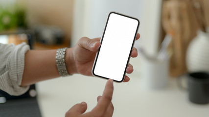 Close up view of male designer showing blank screen smartphone