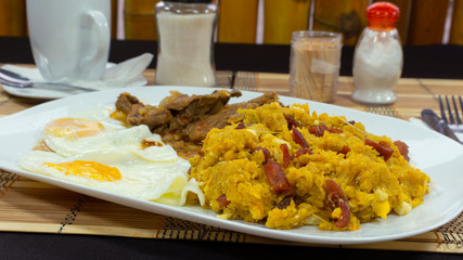 TIGRILLO is a typical dish consisting of ground green banana with cheese served in a green plate on...