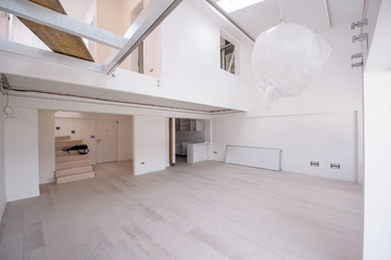 Interior of empty stylish modern open space two level apartment