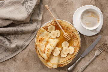 Delicious homemade pancakes with honey on a textural background. Top view, close-up. Traditional holiday celebration concept. Russian translation wide and happy Shrovetide Maslenitsa.