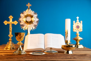 Catholic religion concept. Catholic symbols composition. The Cross, monstrance,  Holy Bible and...