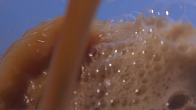 Extreme close up of beer pourring
