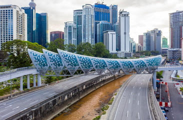 Fototapeta na wymiar Kuala Lumpur, Malaysia - February 22, 2020 : Aerial drone view of newly opened pedestrian bridge Saloma Link connecting Kampung Baru with Ampang road.