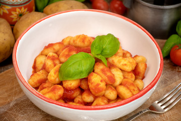 Gnocchi di patata, italian potato noodle with tomato sauce and basil, selective focus