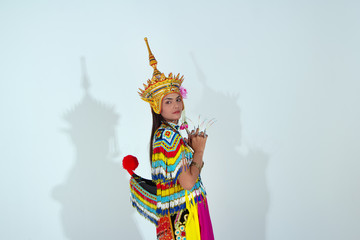 The beautiful woman wearing Thai Tradition southern costume and put headdress on her head,standing on white background,model posing,folk dance,black shadow reflection on white background
