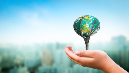 Earth day concept: Human hands holding earth global over  nature background