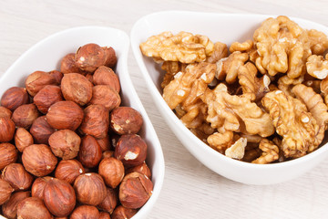 Hazelnuts and walnuts in bowl as source healthy vitamins and minerals, nutritious eating