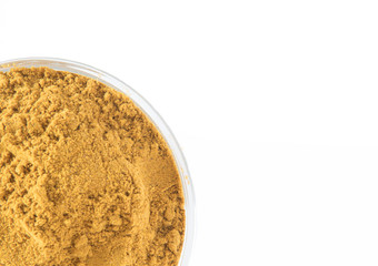 Curry Powder in glass bowl shows partial on white background.  Asian Cuisine with oriental spices. Top View with copy space