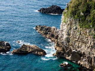Dramatic cliffs and blue ocean waves at Cape Ashizuri, Shikoku's southernmost point -...