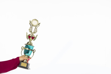 Teenage girls' hands are holding trophies, congratulations on success.Conception of victory in the competition.Focus on the trophy