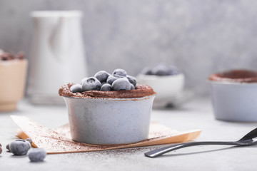 Chocolate Souffle with frozen blueberry . French traditional dessert.
