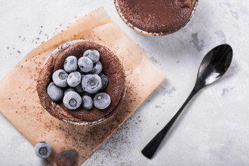 Chocolate Souffle with frozen blueberry . French traditional dessert.