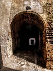 Entrance to the underground medieval street in Cervera town (Catalonia, Spain). Narrow, low, ancient stone-walled tunnel