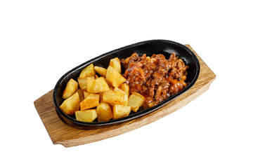 Potatoes with meat, beef, lamb, goulash, fried, baked portion on a hot frying pan, on a wooden board on a white background Side view. For the menu