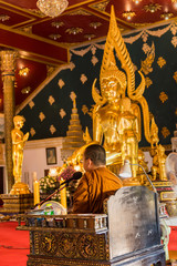 Samut Prakan, Thailand - February,23, 2020 : Thai buddhist Monks praying and pay respect to the Buddha image at Temple wat asokaram ,Thailand