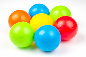 Colored plastic balls on white background