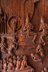 Samut Prakan, Thailand - February,23, 2020 : The image of Buddha's life is carved on the door of entrance the Buddhist temple Asokaram, Thailand.