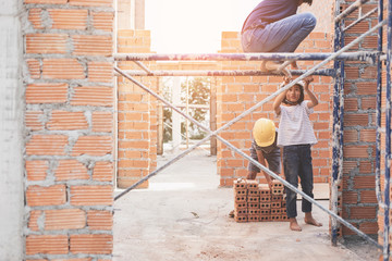 Children working at construction site for world day against child labor concept: