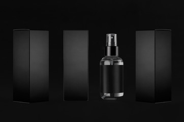 Luxury black mock up for design of packing  cosmetics product - small transparent spray bottles, label, paper boxes sides, dark backdrop.