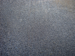 The background is black plastic. Abstract background, plastic, for decoration. Background for the design.