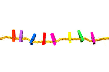 Colorful clothespins weigh on a rope isolated on a white background.