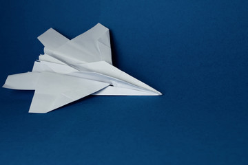 Fototapeta na wymiar Paper plane on a blue background