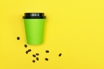 Close up of coffee to go cup  on bright yellow background. Eco concept. Place for text.