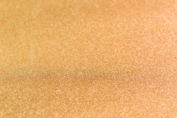 Abstract background texture with golden sparkling glitter. Festive backdrop for greeting cards and other design