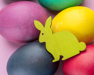 Colorful Easter eggs as an attribute of Easter celebration. Pink background.