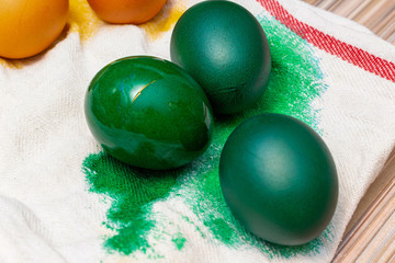 Painting, dying green eggs for Easter on the towel