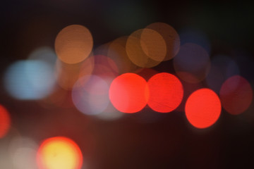 background of bokeh abstract colourful red, gold, blue and black glitter lights. defocused