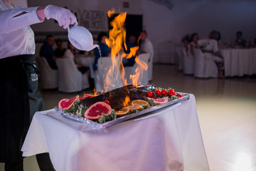 food on fire on a cook's table