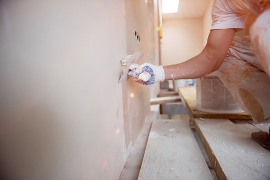 Construction Worker Plastering On Gypsum Walls