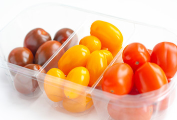 Vegetables, cherry tomatoes in three colors in a plastic transparent box
