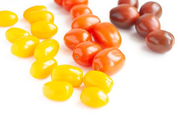 Fototapeta premium Vegetables, cherry tomatoes in three colors on a white background