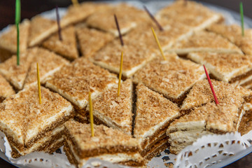 Appetizing portioned cakes on a plate. Close-up.