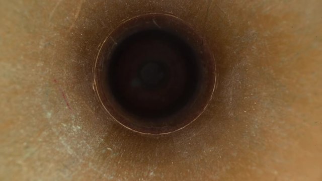 Inside the metal pipe, metallic texture tube. Dolly shot of the lens moving in the pipeline. Perspective view