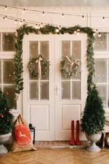 The decor of Christmas and New year. Beautiful facade decorated with wreaths of spruce, selective focus