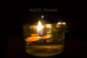 candle,focus on candle with word earth hour on dark background
