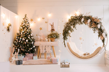 The decor of Christmas and New year.  Children's room decor with a kleka, toys and hanging swings. Wooden table and chair, selective focus