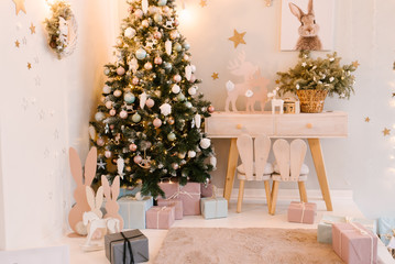 The decor of Christmas and New year.  Children's room decor with a kleka, toys. Wooden table and chair, selective focus