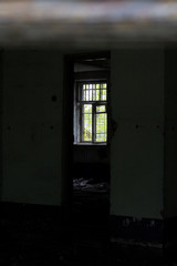 Fototapeta na wymiar Broken, boarded up windows in an abandoned building