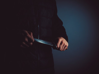 A man with a knife in his hands. 