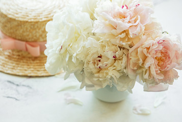 Straw hat and peonies