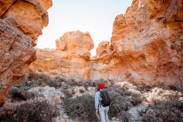 Landscape of a beautiful rocks on the desert valley with woman traveling at the natural park near...