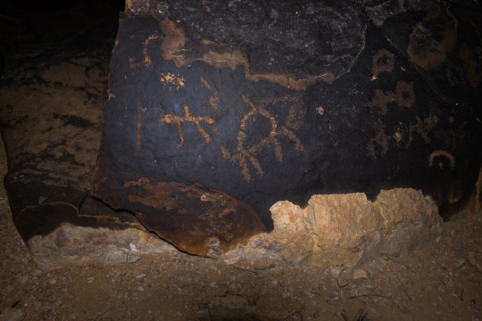 A night view of a drawing depicting an animal carved in stone by a primitive man in the desert in southern Israel near the Avdat fortress