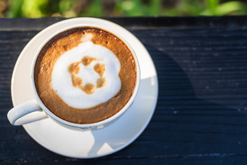 Hot coffee, hot latte in a white cup on a wooden table
