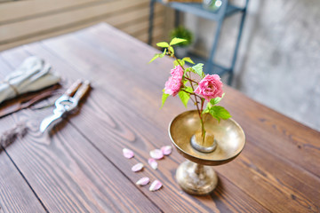 Fototapeta na wymiar Ikebana in kenzan, scissors and pruner on the table florist. Seasonal summer garden flowers.