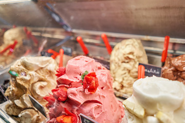 Fruit with strawberries Gelato. Flavors various ice cream in Rome, Italy. Italian gelateria. Assortment of colorful gelato on cafe showcase. Natural fresh ice cream.