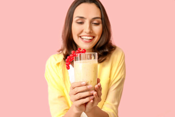 Young woman with tasty yogurt on color background